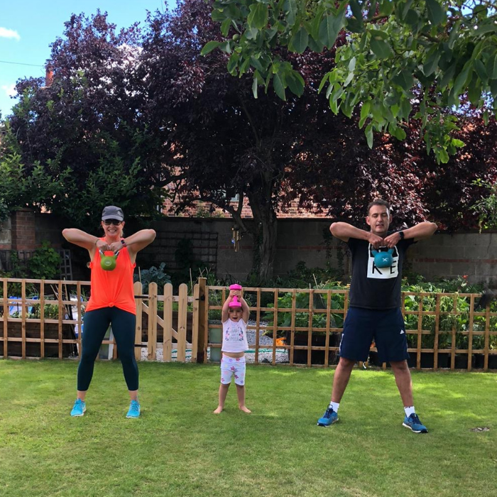 Energised and happy mum doing exercise with her family