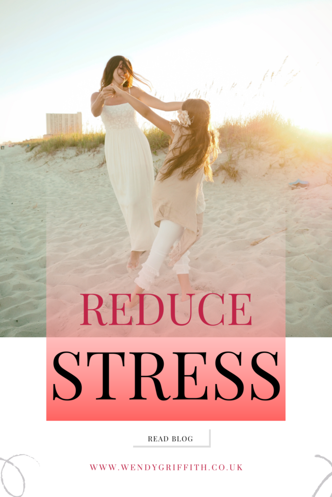 The background image of this pin is one of a mother and daughter holding hands and dancing in circles. They are wearing summer clothes - the mum is wearing a simple beige dress and the daughter is wearing a beige top and white trousers with ruffles. They're on the beach at sunset. The pin is captioned: Reduce stress - read blog, because it leads to my blog called How busy mums can reduce stress in which you can read about various types of stress we can face and 6 tips on how to combat stress.